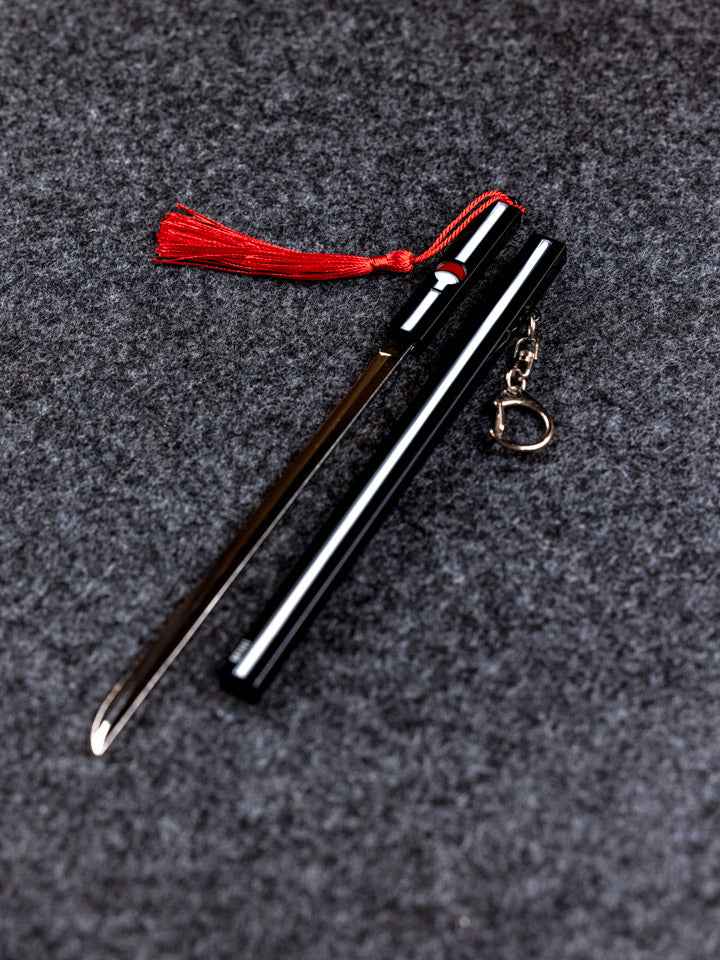 Sasuke Grass Cutter Keychain + Stand — close-up detail view